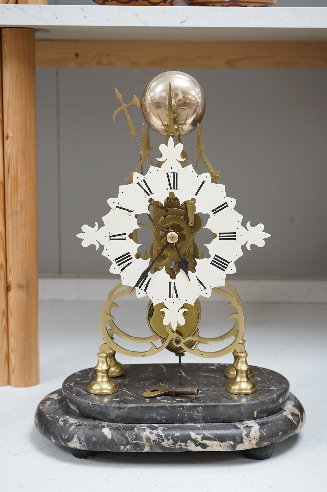 A large skeleton clock under dome, on grey marble base. 44cm high